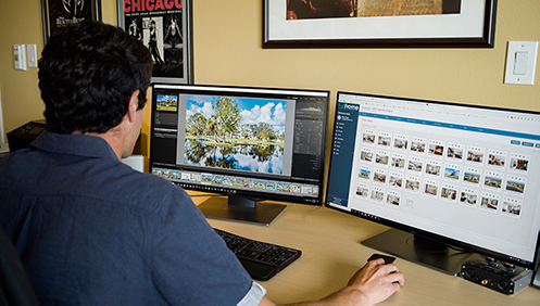 Person editing photos and using Full Frame Systems on the computer
